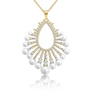 Conjunto ovalado con piedras redondas, baguettes y perlas, dorado. Largo aprox del dije 4,5 cm