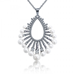 Conjunto ovalado con piedras redondas, baguettes y perlas, rodio negro. Largo aprox del dije 4,5 cm