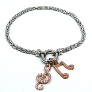pulsera fope fina con dijes notas musicales rosadas con piedras